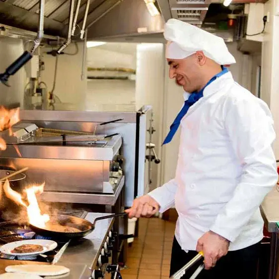 Estrella Estates Chef Created Meals, chef frying a dish.